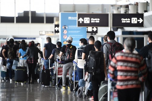 Travelers wait to check in at Rome's Fiumicino airport on June 3, 2020, as airports and borders reopen for tourists and residents free to travel across the country, within the COVID-19 infection, caused by the novel coronavirus.,Image: 526153156, License: Rights-managed, Restrictions: , Model Release: no